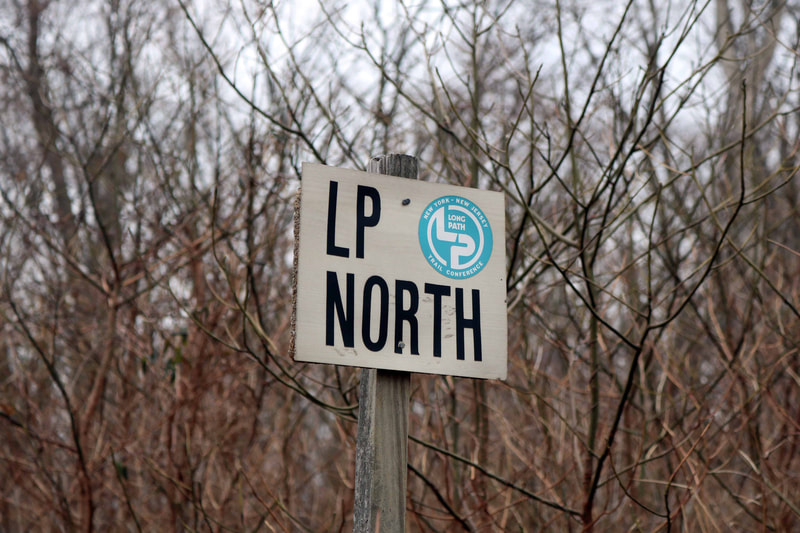 Grey sign reading LP (Long Path) North.
